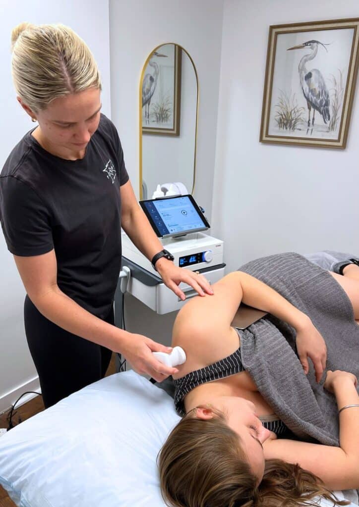 physiotherapist applying TECAR therapy for shoulder pain treatment in West End Brisbane clinic