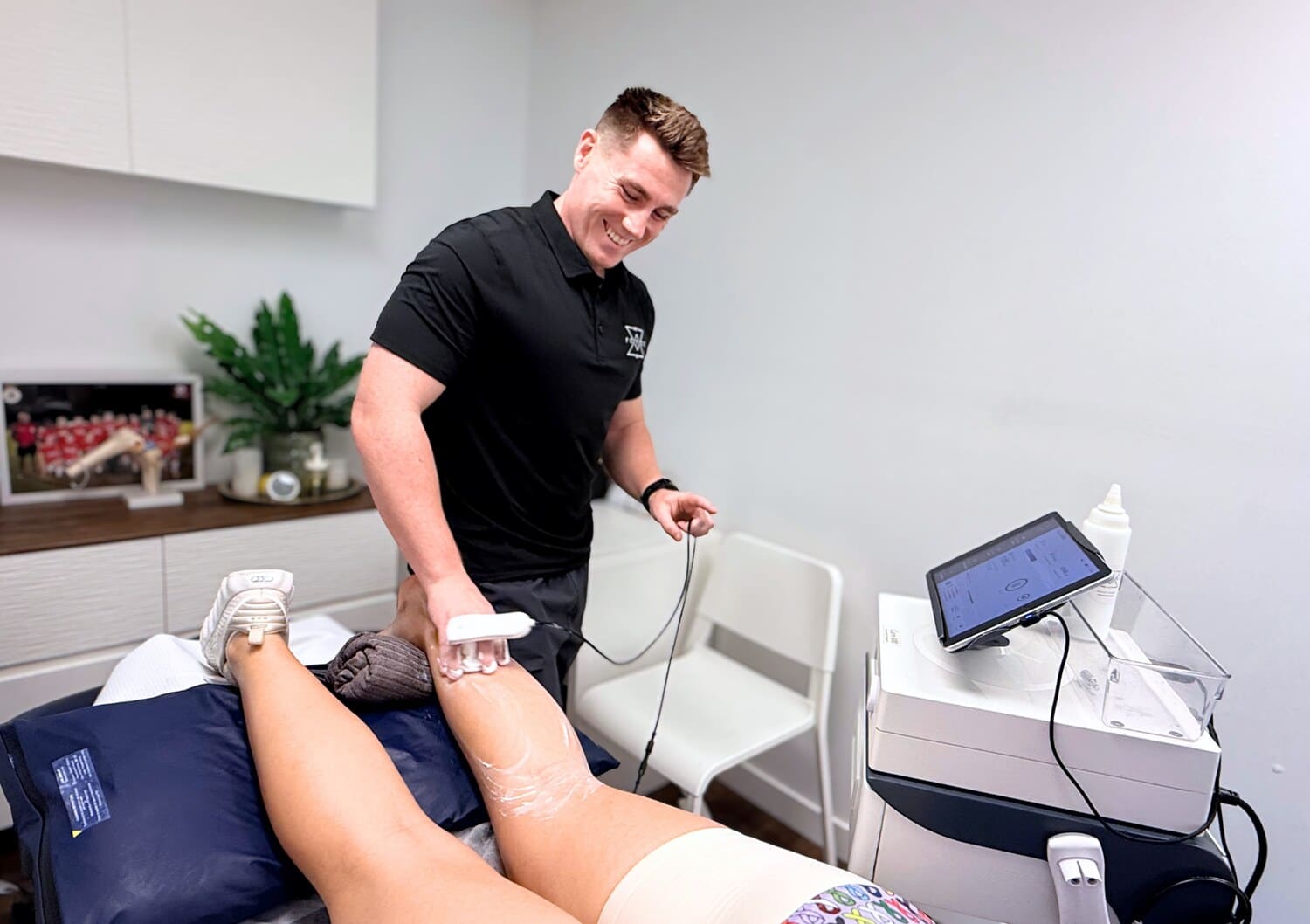 Physiotherapist delivering TECAR therapy to a patient&rsquo;s leg at Forge West End, Brisbane